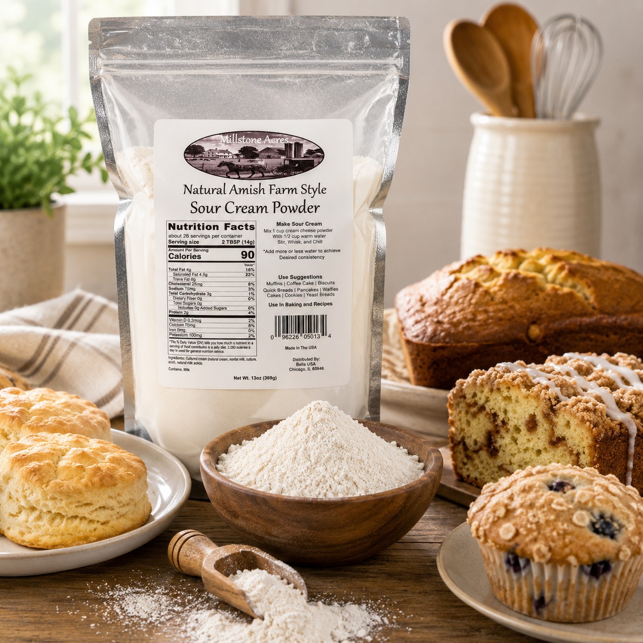 Millstone Acres Natural Sour Cream Powder displayed with biscuits, muffins, coffee cake, and homemade baked goods in a bright farmhouse kitchen.
